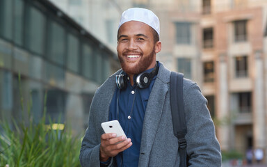 Portrait, phone and muslim with an man in the city on his morning commute listening to music during...
