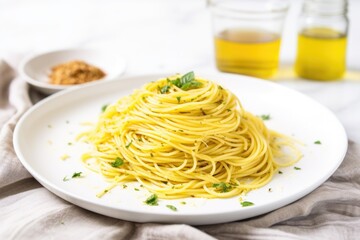 spaghetti tossed in olive oil and garlic on a white plate