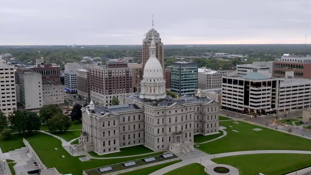 Michigan State capitol building in Lansing, Michigan with drone video wide shot moving in a circle.