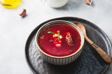 Traditional Ukrainian beet soup - borscht on the grey background
