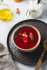 Traditional Ukrainian beet soup - borscht on the grey background vertical photo