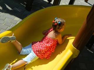 Kids having fun in ferris wheel with chains, carousel ski flyer in amusement park in Targoviste,...