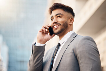 Phone call, happy and young businessman in the city in a company consultation or conversation. Smile, technology and professional male lawyer talking on a cellphone for communication in an urban town