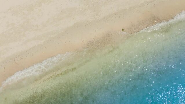 Beach sand for summer vacation concept. Beach nature and summer seawater with sunlight light sandy beach Sparkling sea water contrast with the blue sky.Beach sand for summer vacation concep