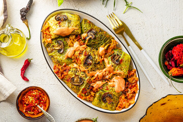 Savoy cabbage stuffed with mushrooms top view, vegetarian dish, white background
