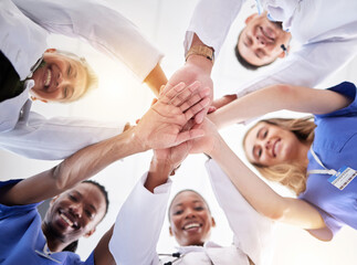 Fototapeta na wymiar Hands, healthcare and a team of doctors in a huddle in the hospital together from below. Medical, diversity and solidarity with a medicine professional group standing in a circle in a clinic