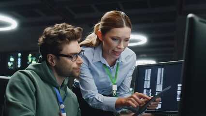 Data center analysts working in server room closeup. IT specialist showing data - Powered by Adobe