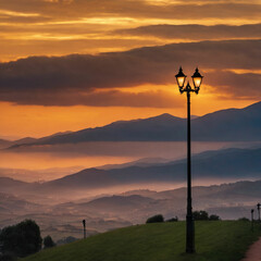 Hills and street lamps under a cloudy sky during a beautiful sunset