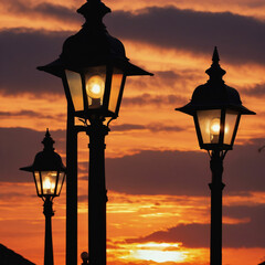 Obraz premium Hills and street lamps under a cloudy sky during a beautiful sunset