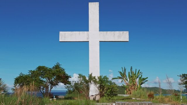 Giant white cross at the Old Catholic Cemetery in Claver, Surigao del Norte , Philippines dolly zoom shot effect