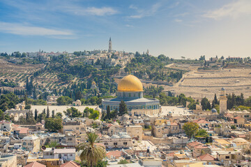 Jerusalem Old City cityscape, the famous Dome of the Rock, a Muslim shrine, shines on top of the Temple Mount also known as Haram al-Sharif. The Mount of Olives is in the background