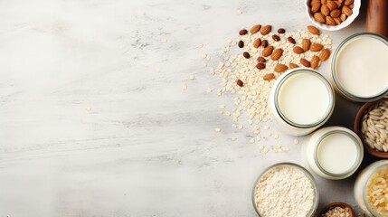 Obraz na płótnie Canvas Food and drink, health care, diet and nutrition concept. Assortment of organic vegan non dairy milk from nuts, oatmeal, rice, soy in glasses on a kitchen table. Copy space top view flat lay background