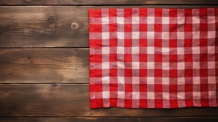 Fototapeta na wymiar Red picnic cloth on wooden background.Napkin tablecloth on old wood with empty space for text.