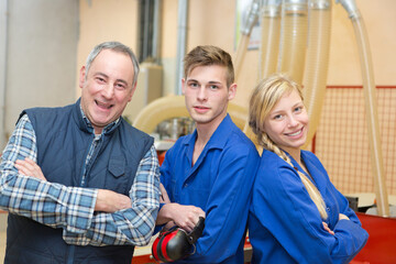 portrait of young people working at carpenter shop