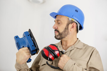 worker making repair in room