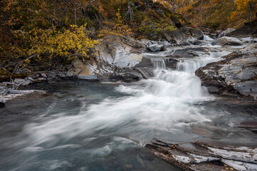 Fototapeta premium Beautiful Autumn Scenery in the Swedish Lapland with creek and flowing water