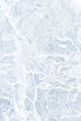 Obraz premium Defocus blurred transparent blue colored clear calm water surface texture with splashes reflection. Trendy abstract nature background. Water waves in sunlight with copy space. Blue watercolor shine.