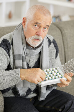 worried senior man with taking his medication