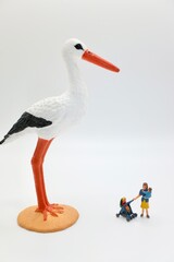 mom with child and a stork miniature figurines