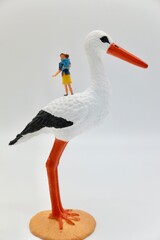 mom with child and a stork miniature figurines