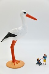 mom with child and a stork miniature figurines © marco