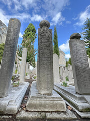 Ottoman Tombstone columns in cemetery of sultans at backyard of Suleymaniye Mosque in Istanbul, Turkey.