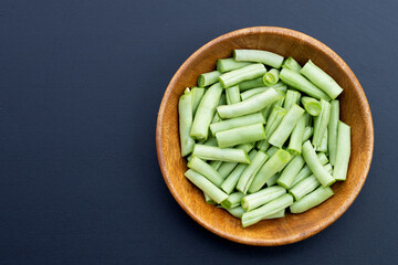Green beans on dark background.