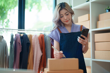 Asian female business owner handles delivery of orders to customers