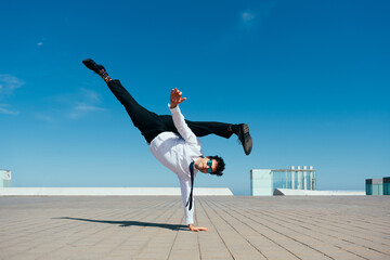 Flexible and cool businessman doing acrobatic trick