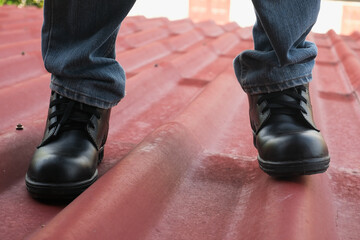Wear safety shoes to ensure safety at work. construction workers wear safety shoes. People with factory safety concept