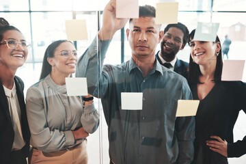 Planning, brainstorming and business team in a meeting of strategy development at a startup company in the office. Leader, founder and businessman doing a presentation in teamwork with sticky note