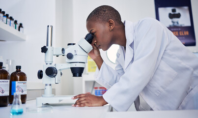 Microscope, science and black woman in laboratory to check research, medical analysis and study...