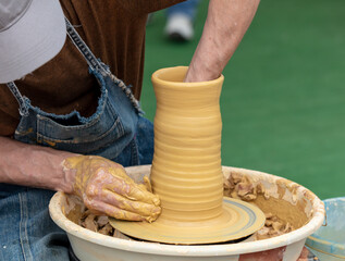 Clay craftsman sculpts crockery . Close-up.