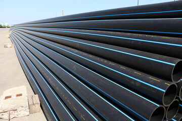 PE pipe plant, Industrial PE pipes with blue line for gas and water. HDPE pipe, Polyethylene PE100 pipe. Polyethylene pipe plant