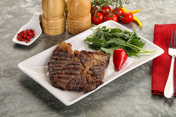 Grilled chuck roll steak with arugula