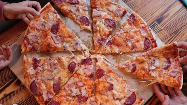 Top View Of Pizza And Human Hands Taking Pizza Slices From Box In Cafe Having Lunch Or Delivering Takeaway Dish Fast Food Enjoying Tasty Dinner.