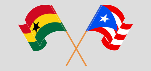 Crossed and waving flags of Ghana and Puerto Rico