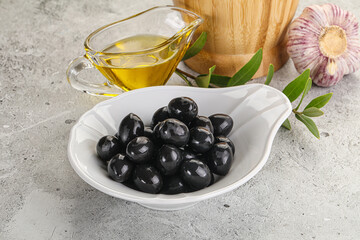 Black olives with oil and branch