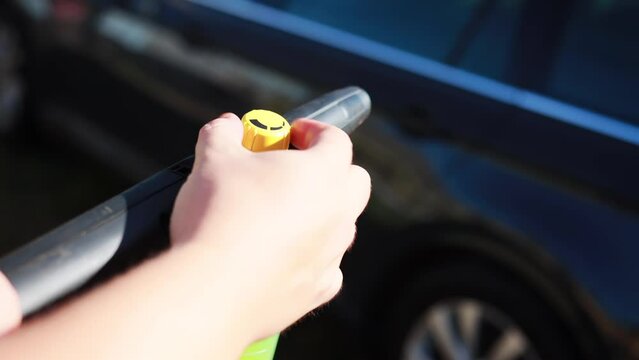 adjusting the supply of foam and shampoo in a high-pressure mini washer. shampoo nozzle, close-up