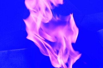 Purple flames, abstract swirls of lilac smoke on a blue background.