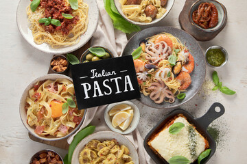Assortment of Italian pasta dishes on light bachground. Traditional food concept.