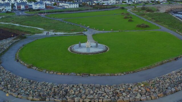 Cinematic aerial pullback featuring the Celia Griffin Memorial Park in Salthill, Ireland.