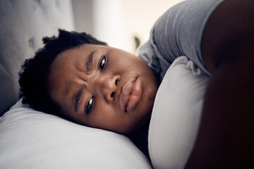 Black woman, depression and insomnia with mental health problem, tired and stress with anxiety at home. Female person in bed, depressed and psychology with life crisis, sad with fatigue and grief - obrazy, fototapety, plakaty
