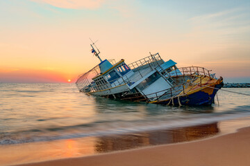 Old fishing boat abandoned in the sea, Chonburi, Thailand