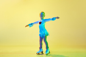 Full-length of cute, beautiful adorable kid, little girl, dancing, performing figure skating...