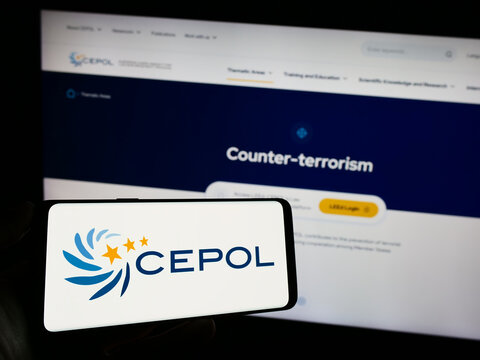 Stuttgart, Germany - 10-17-2023: Person holding mobile phone with logo of European Union Agency for Law Enforcement Training (CEPOL) in front of web page. Focus on phone display.