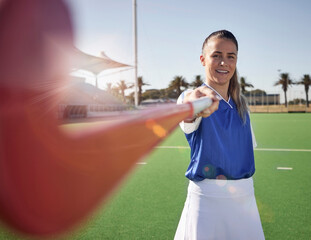 Woman hockey player, closeup and portrait on field with smile, hockey stick and happy in sunshine....