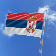 Serbia flag fluttering in the wind on sky.