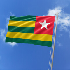 Togo flag fluttering in the wind on sky.