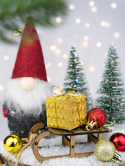 Christmas composition with a Christmas gnome and Christmas decor. Close-up. Selective focus.